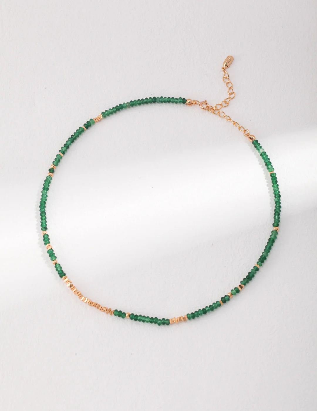 Full-length view of Emerald Green Choker with gold chain and green beads.