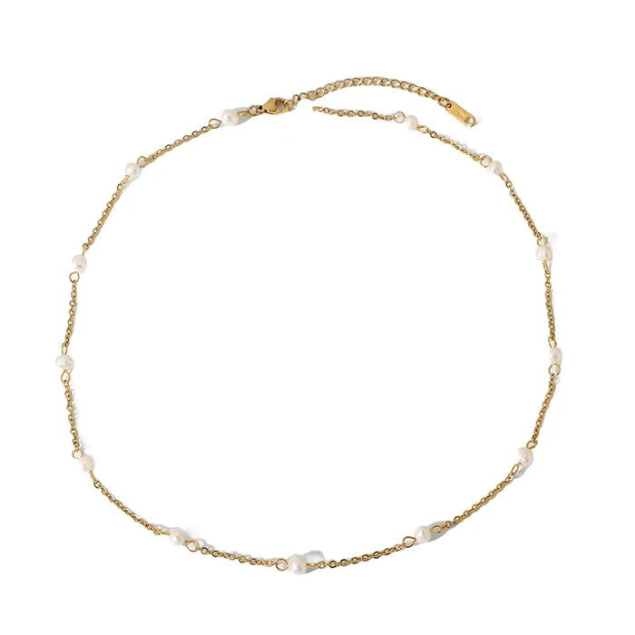 Flat display of the Aimee Gold Freshwater Pearl Chain Necklace, highlighting the elegance of each freshwater pearl set on a dainty gold chain, ideal for classic and sophisticated styling.