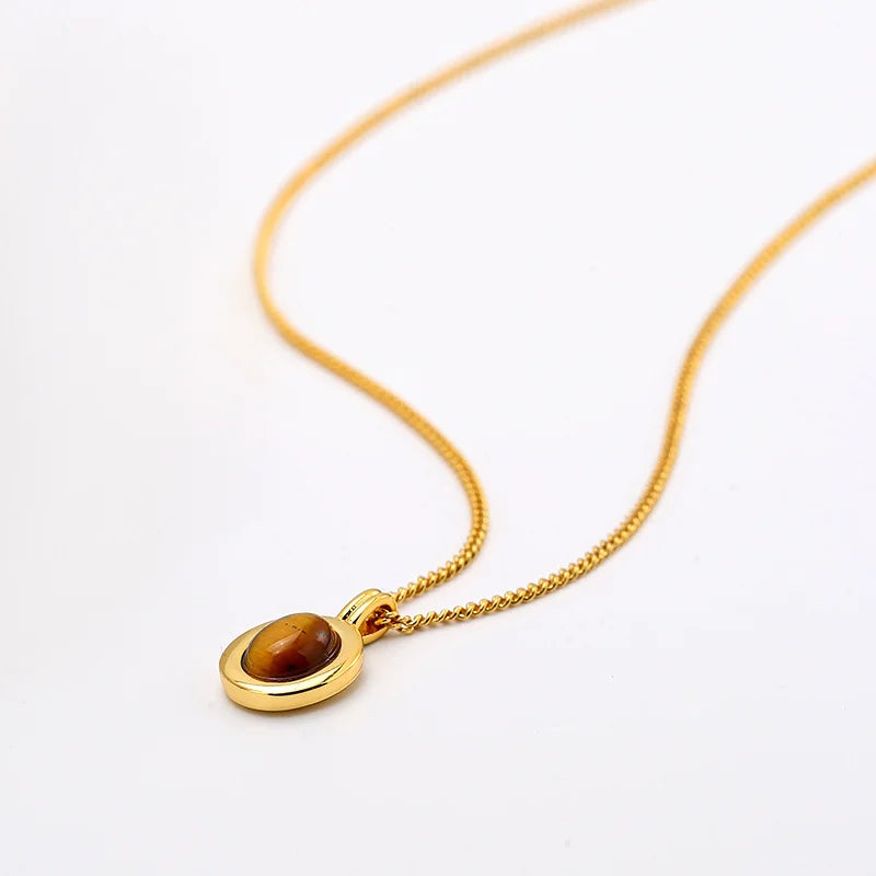 Elegant gold chain necklace featuring a captivating Tiger's Eye pendant, showcasing a warm and earthy gemstone charm