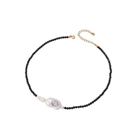 Elegant black onyx beaded necklace with a large natural pearl centerpiece, complemented by small pearl accents and a gold extension chain, showcased on a neutral background.