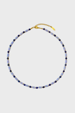 Close-up of the Ancient Sky Stone Celeste Necklace featuring alternating cylindrical and round blue gemstones, with 18K gold-plated clasp on a white background.
