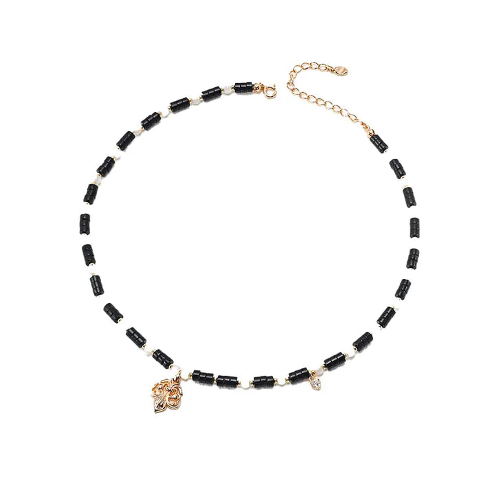 Close-up of the Anna Pure Silver Vintage Black Onyx Necklace, featuring black onyx beads with gold and silver accents, elegantly displayed on a white background