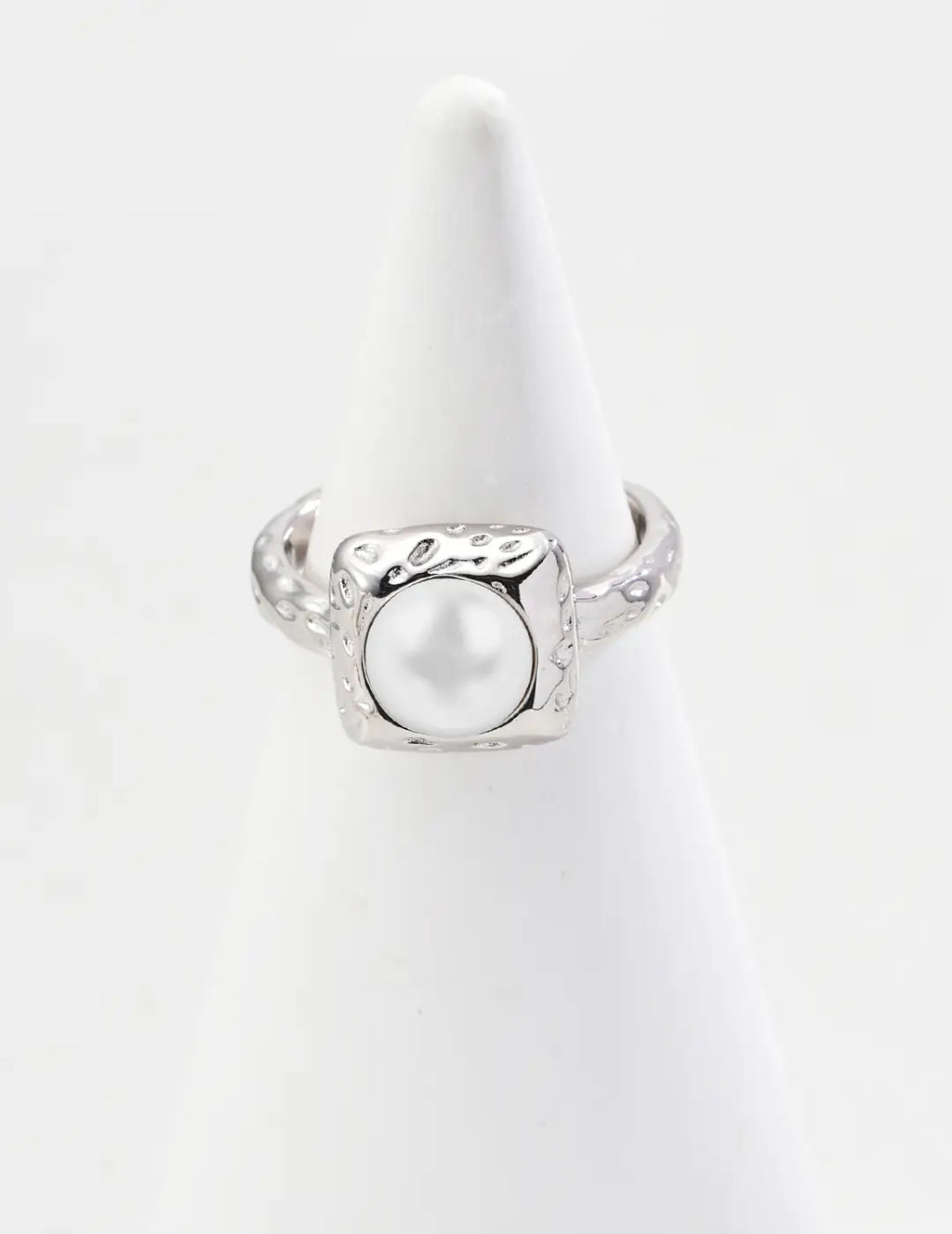 Silver ring with a pearl on a white background