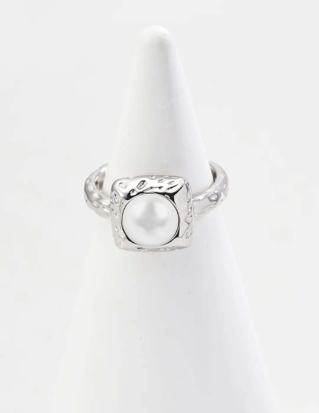 Silver ring with a pearl on a white background