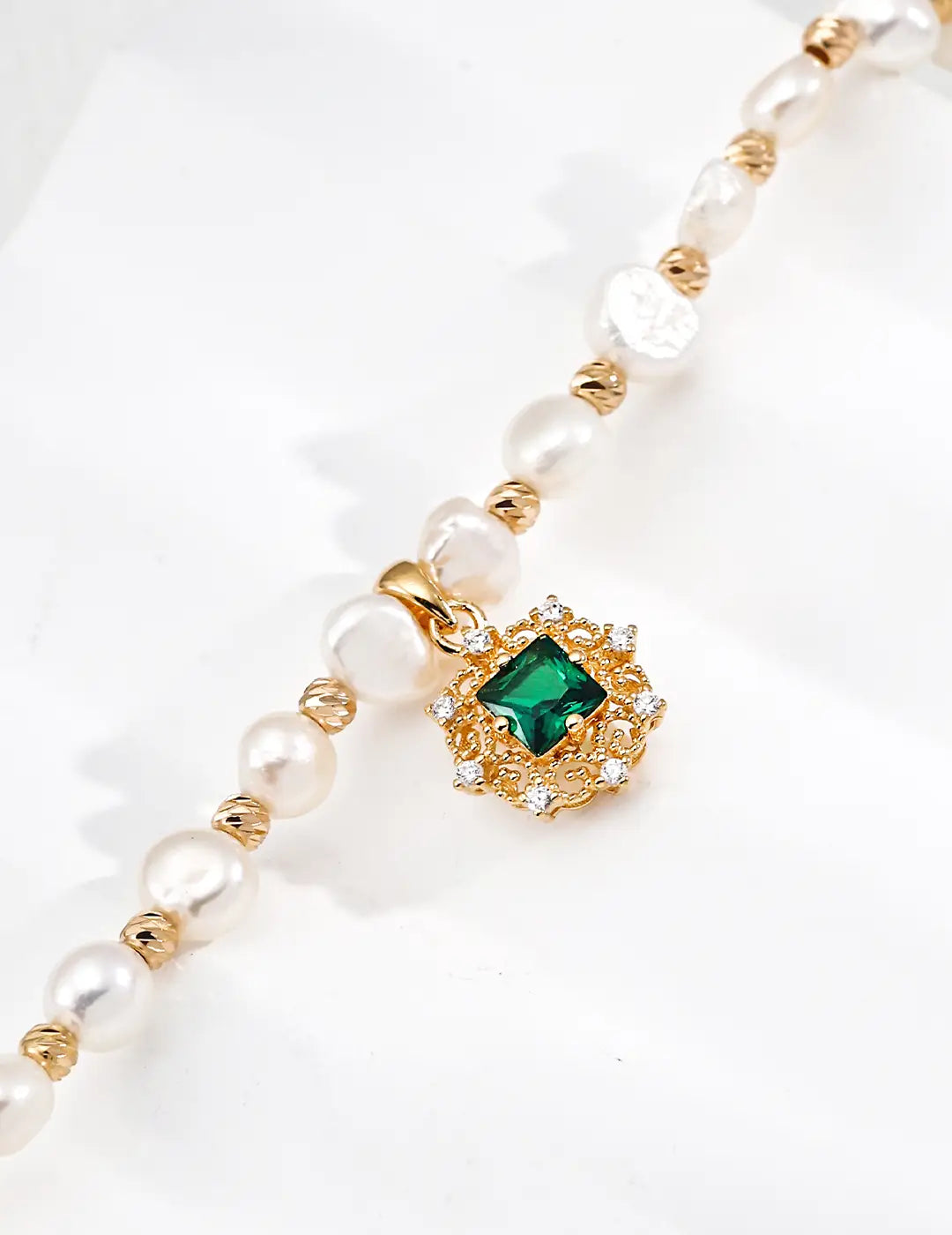 Pearl bracelet UK – close-up of CZ halo green charm