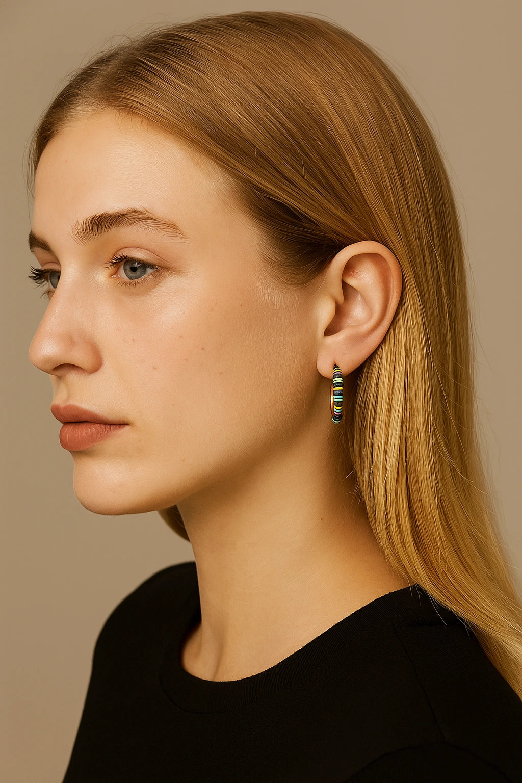 Side view of model wearing gold hoop earrings with turquoise and lapis beads