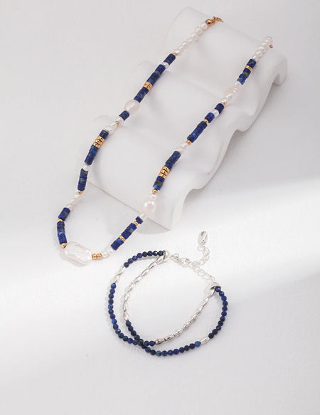 Gold choker with navy lapis lazuli beads and baroque pearls, perfect for elegant occasions