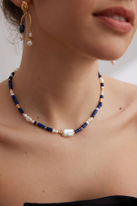 Close-up of the Navy Blue Lapis Lazuli Beads with Baroque Pearls Choker by Anaïs & Aimee on a model, capturing the intricate details of the lapis beads and baroque pearls.