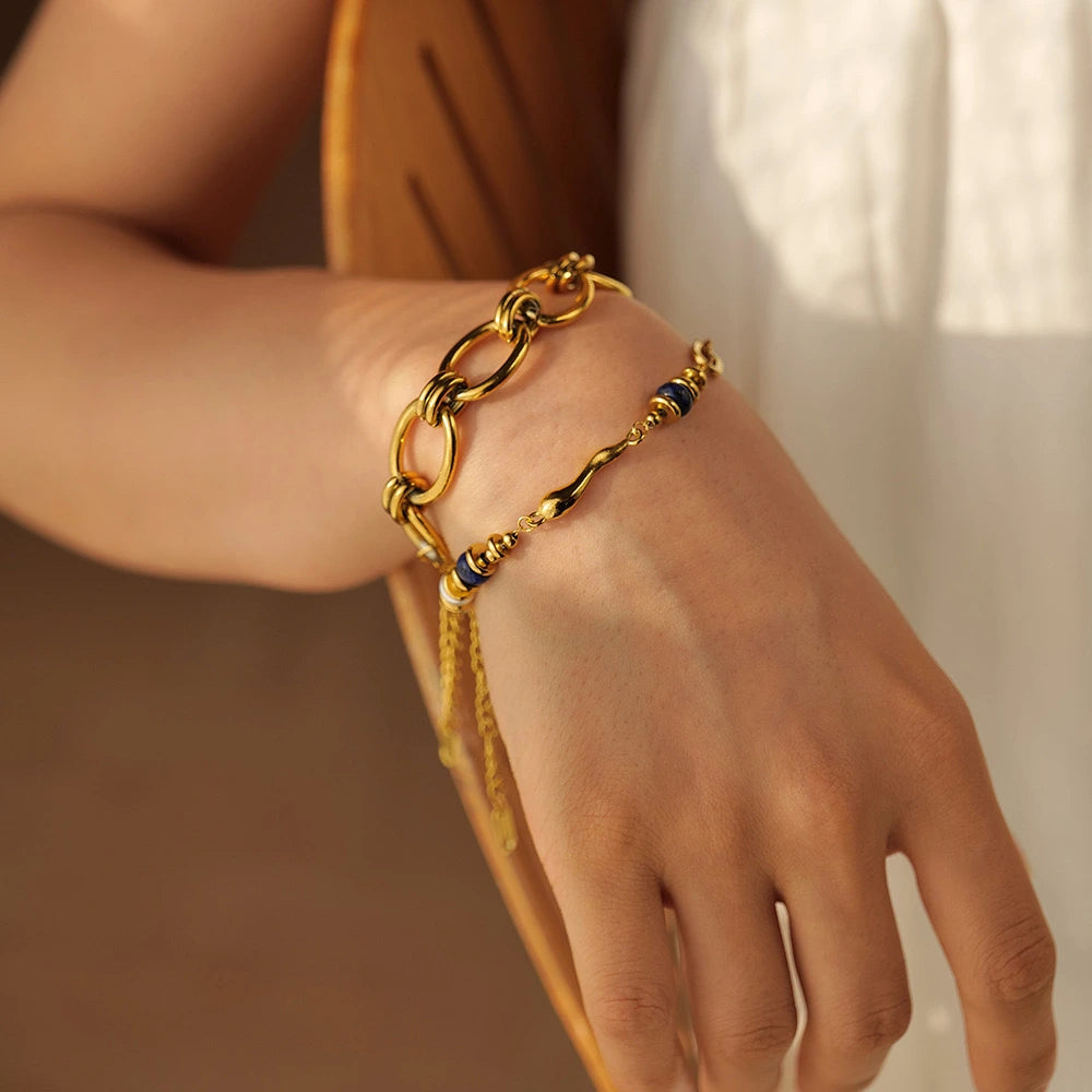 Close-up of a gold bracelet with lapis lazuli stone beads, pearl details, and luxe finish, showcasing lapis lazuli jewellery UK style