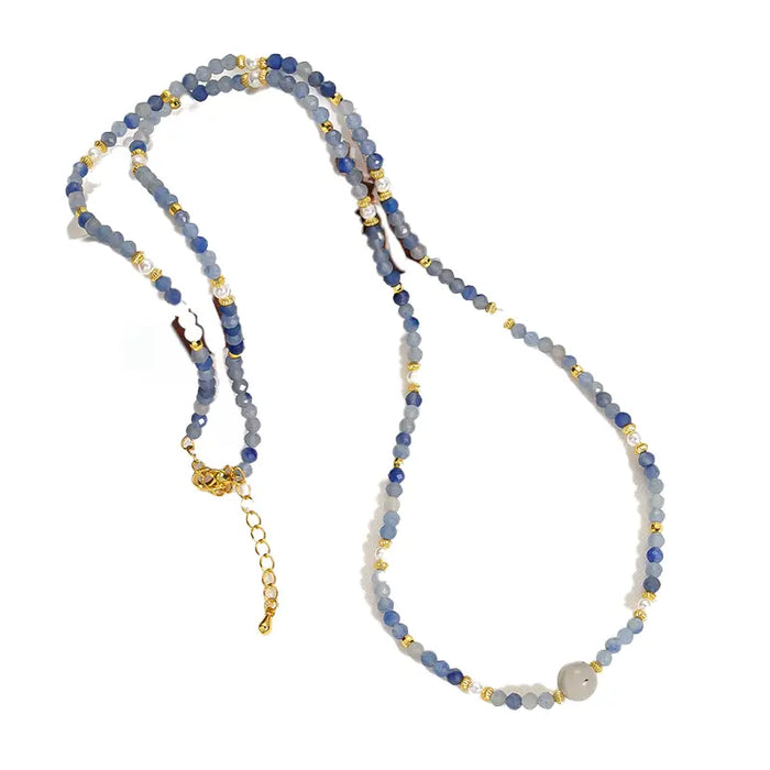 Camile Turquoise Lapis Lazuli Pendant Necklace featuring blue beads with gold accents, displayed on a clean white background.