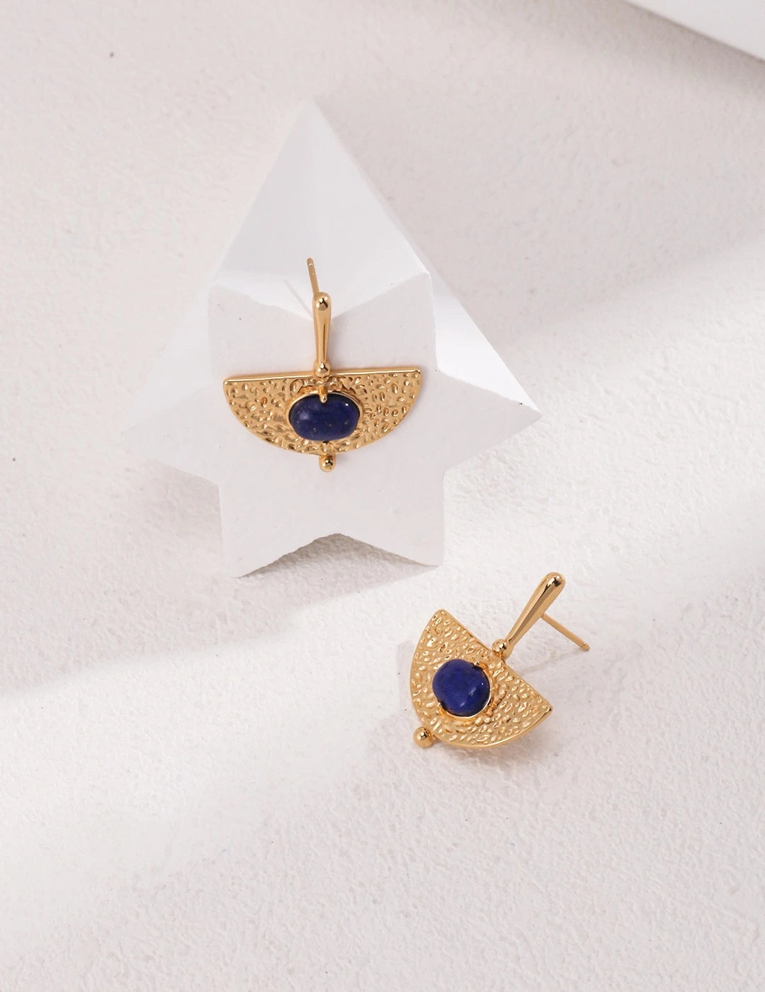 Flat lay of Celeste Lapis handmade gold earrings – blue lapis gemstone statement earrings UK by Anais & Aimee