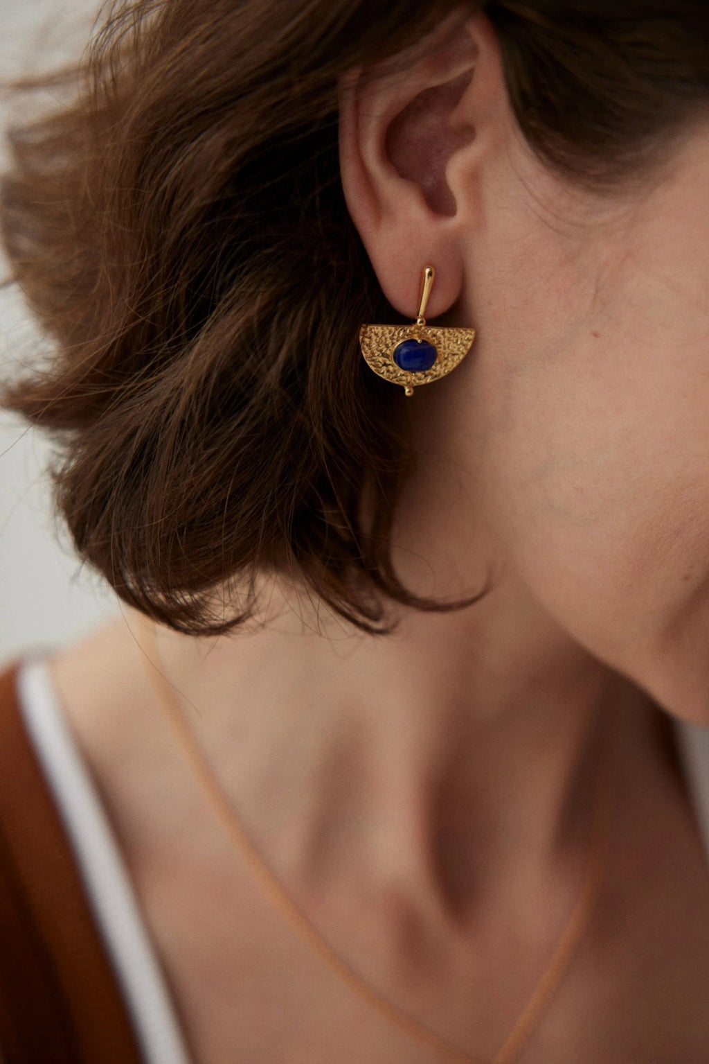 Model wearing handmade lapis gemstone earrings – gold statement earrings UK by Anais & Aimee