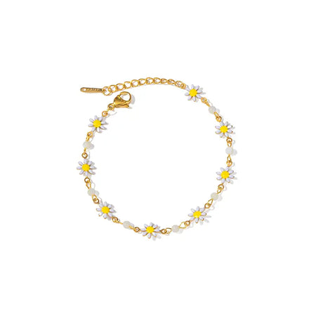 Anais & Aimee Dainty White Flower Bracelet - a charming gold-plated chain bracelet adorned with delicate white and yellow flower charms. Perfect for adding a touch of springtime elegance to any outfit. Ideal for young, fashion-forward individuals seeking unique and whimsical jewelry pieces.