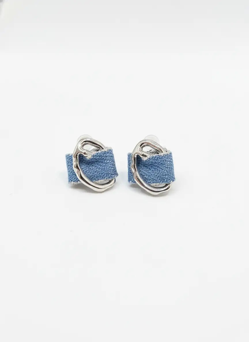 Pair of denim hoop earrings on a white background