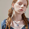 Model wearing the Denim Heart Sterling Silver Necklace and matching hoop earrings, styled with a denim corset top for a chic and modern look