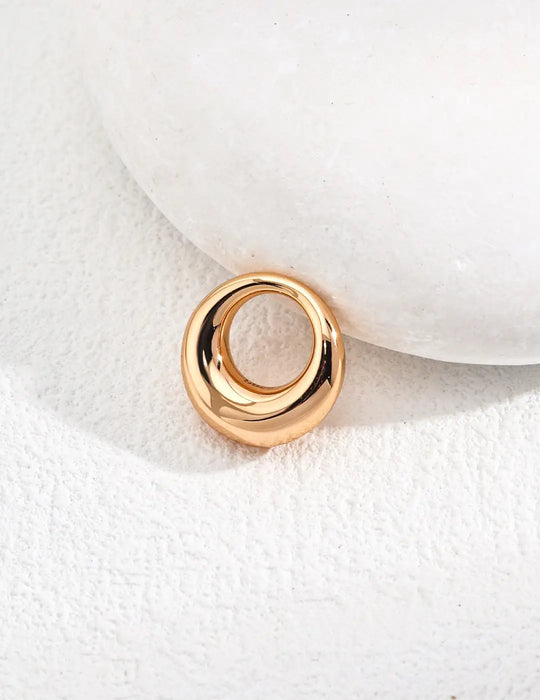  A close-up of the gold donut pendant from the Donut Sterling Silver Agate Necklace, highlighting its smooth and polished surface.