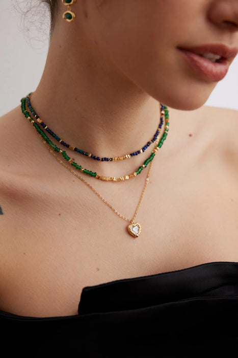 Close-up of the Emerald Green Necklace Choker on a model by Anaïs & Aimee, highlighting the gold stones and adjustable chain design for a versatile look.