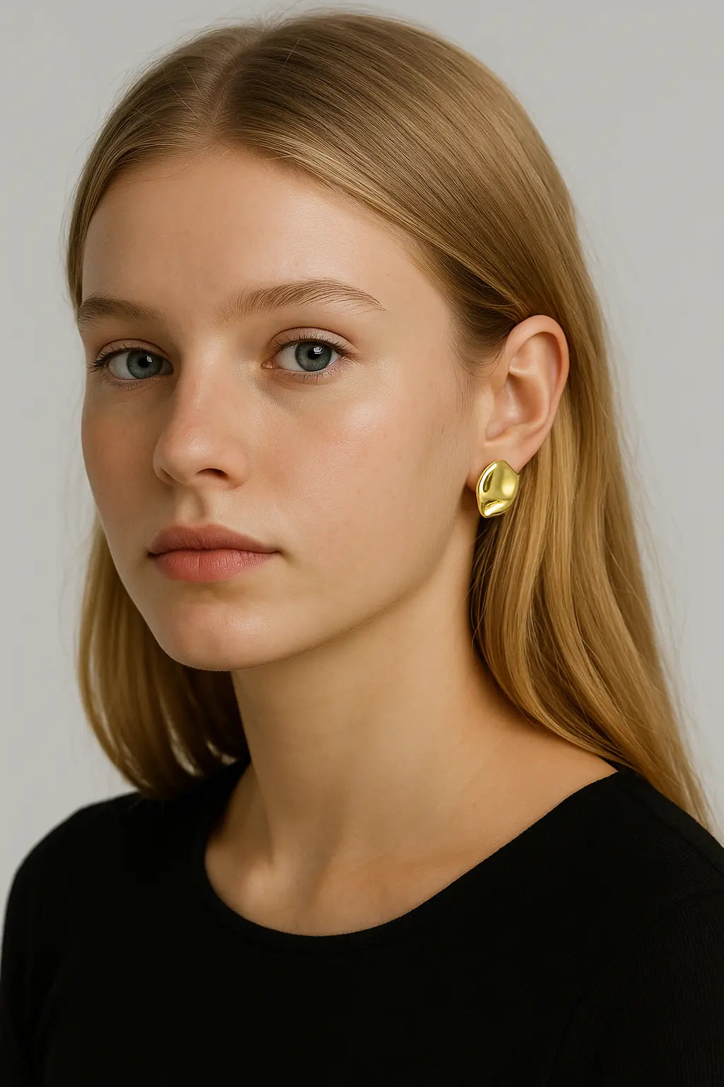 18-year-old European girl with blonde hair wearing Essence Sculptural Gold Statement Earrings