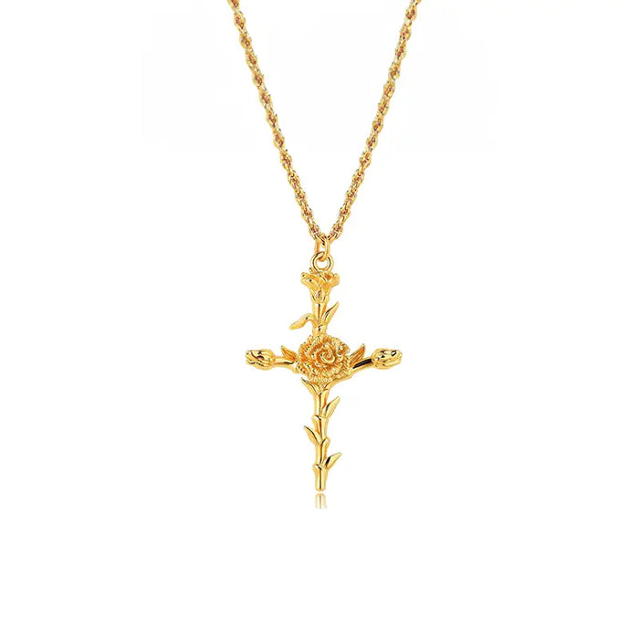 A gold necklace featuring a pendant shaped like a cross adorned with a detailed rose in the center and smaller floral elements extending from the arms of the cross. The chain is also gold with a twisted design. The pendant and chain create a cohesive and elegant piece of jewelry.