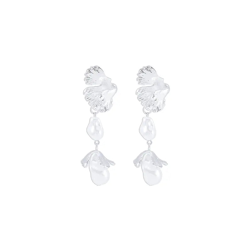 Each earring starts with a delicate leaf motif at the top, detailed with intricate vein patterns that highlight the ginkgo leaves naturalistic design. Suspended from the leaf are two irregularly shaped baroque pearls, creating a graceful cascade. The earrings shimmer with a pure, silvery sheen, offering a sophisticated and elegant accessory option.