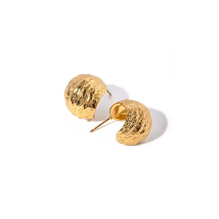 A pair of crescent moon-shaped stud earrings in textured gold. The earrings are crafted to resemble the rough, natural surface of a lunar landscape, with a rich, glossy finish that catches the light. The subtle curves and contours of the earrings enhance their three-dimensional appeal, making them a striking accessory on a plain white background