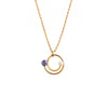 Anais & Aimee Lapis Lazuli Drop Necklace featuring a gold chain with interlocking circular pendants, adorned with a deep blue lapis lazuli stone and a lustrous white pearl. Perfect for adding a touch of elegance and sophistication to any outfit.