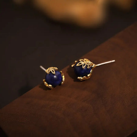 Stunning Lapis Lazuli Golden Leaf Stud Earrings by Anais & Aimee, featuring genuine lapis lazuli stones encased in a delicate gold leaf design, perfect for women's unique gemstone jewelry and elegant fashion accessories.