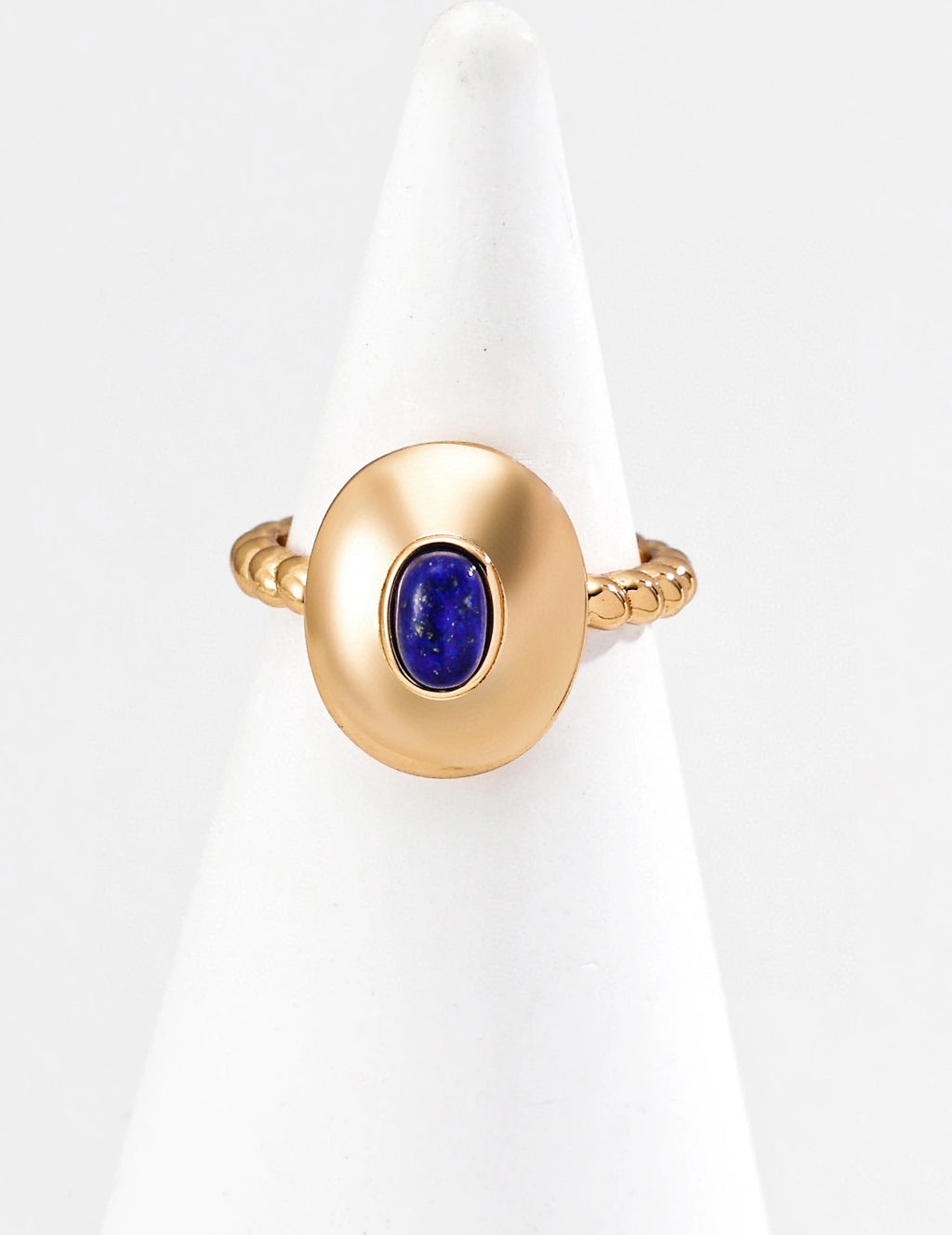 Gold ring with a blue gemstone on a white background