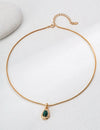 Elegant Lille Necklace featuring a gold chain and emerald stone by Anaïs & Aimee, designed for modern UK jewelry lovers