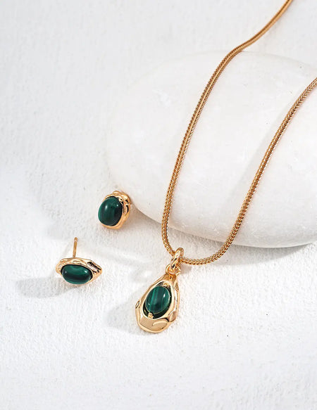 Delicate gold necklace with a green emerald pendant from Anaïs & Aimee's collection, ideal for stylish UK women seeking luxury jewelry.