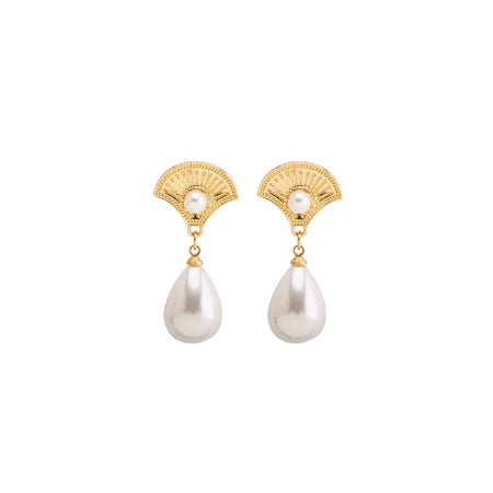 Each earring consists of a decorative gold fan-shaped element at the top, intricately designed with filigree patterns and a central pearl. Below this, a larger, smooth, teardrop-shaped pearl is suspended, providing an elegant contrast against the detailed top. The overall design combines classic elements with a touch of sophistication, making these earrings suitable for both formal and everyday wear.