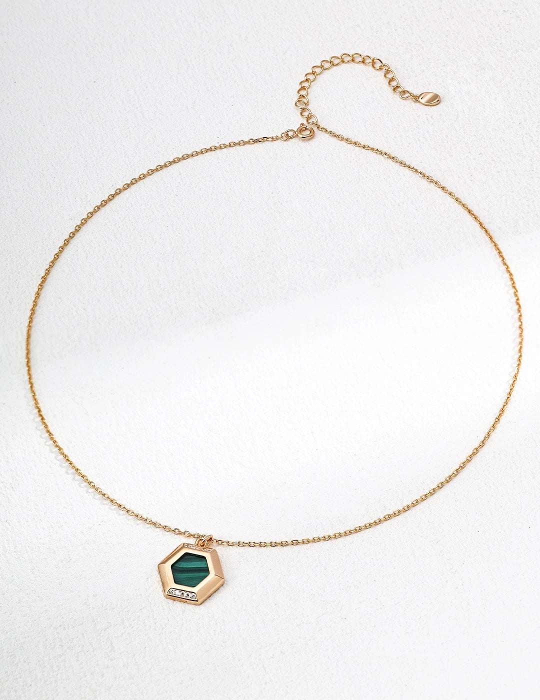 Nove Malachite Pendant Necklace with a green hexagonal pendant on a white background