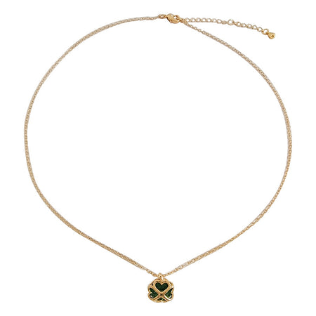 The image features a delicate gold necklace with a unique charm at the center. The charm is designed as a heart intertwined with a cross, set with a dark emerald green centerpiece. The necklace includes an adjustable chain, providing a versatile fit, and the charm's intricate details are enhanced by the gold setting, giving it a sophisticated and elegant look.