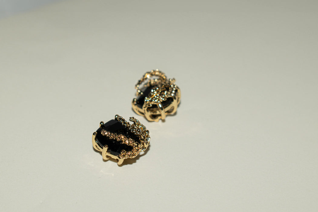 Patchouli Flower Black Obsidian Stud Earrings by Anaïs & Aimée, side view highlighting the gold accents wrapping around the black gemstone.