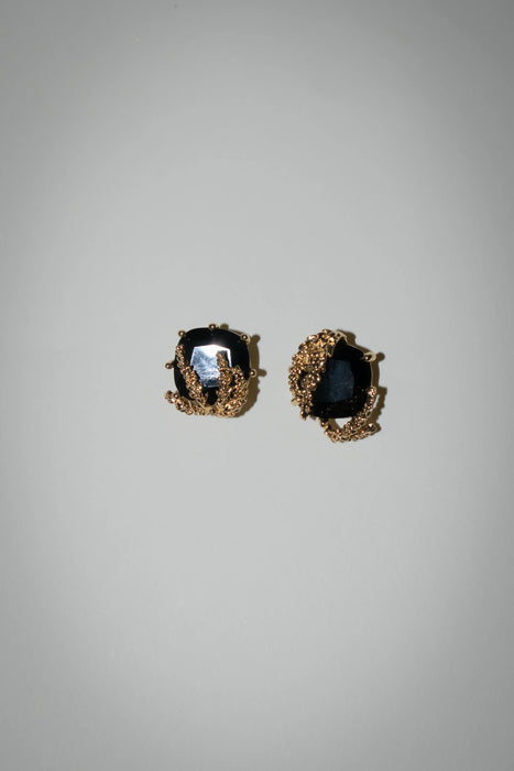 Patchouli Flower Black Obsidian Stud Earrings by Anaïs & Aimée, front view showcasing intricate gold detailing around a black gemstone."

Second Image: "Patchouli Flower Black Gem Stud Earrings by Anaïs &
