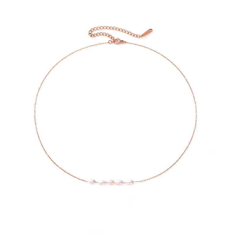 Rose Gold Freshwater Pearl Necklace with delicate pearls strung on a fine rose gold chain, featuring an adjustable clasp for a perfect fit. Elegant and timeless jewelry piece.