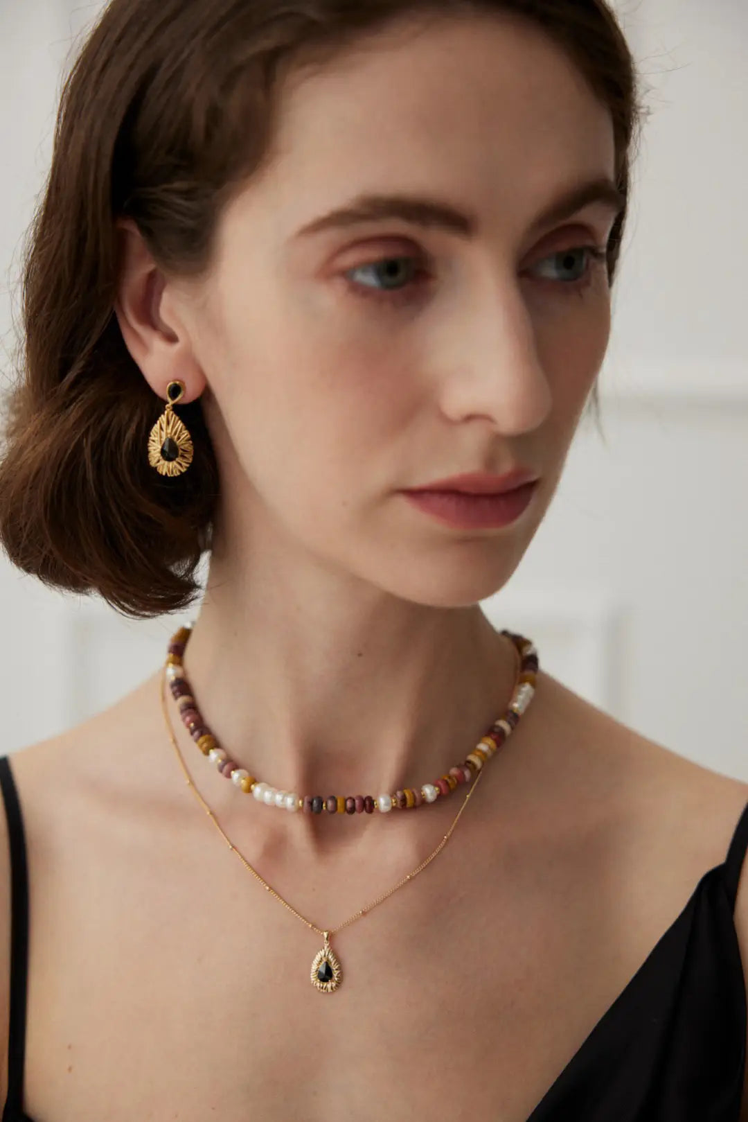 Anais & Aimee Royal Black Zirconia earrings on a model, showcasing their refined craftsmanship and sleek modern design for confident and stylish looks.