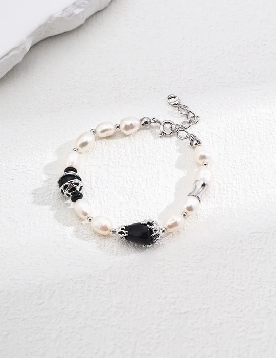 Close-up of the Serenity Black Obsidian Pearl Bracelet by Anaïs & Aimee in silver. This version features polished pearls, black obsidian gemstones, and sleek silver details for a refined, modern aesthetic in the UK