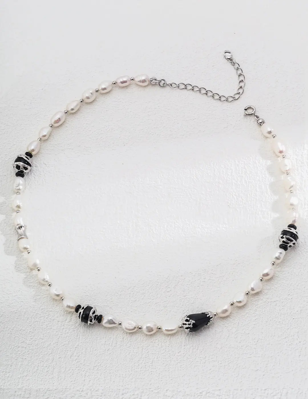 Close-up of the Serenity Black Obsidian Pearl Necklace by Anaïs & Aimee in silver. This version combines shimmering pearls, black obsidian gemstones, and sleek silver accents, perfect for modern elegance in the UK