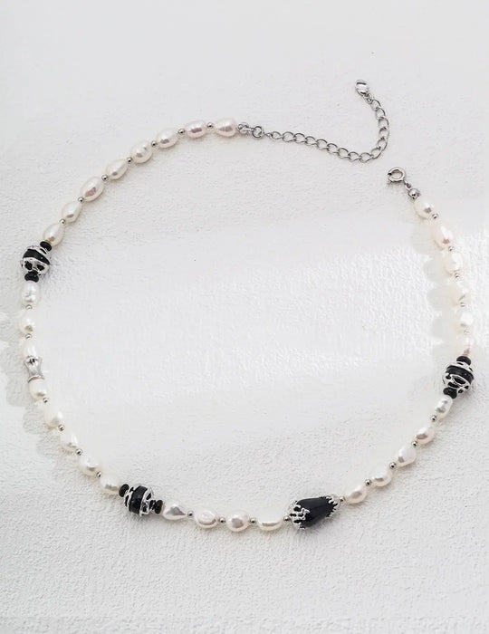 Close-up of the Serenity Black Obsidian Pearl Necklace by Anaïs & Aimee in silver. This version combines shimmering pearls, black obsidian gemstones, and sleek silver accents, perfect for modern elegance in the UK