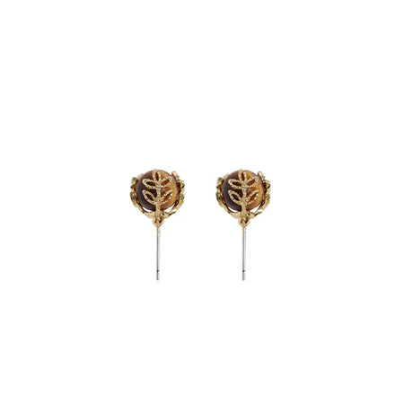 Elegant Anais & Aimee Tiger’s Eye Juniper Stud Earrings featuring rich tiger’s eye gemstones encased in intricate gold-plated juniper leaf designs, with hypoallergenic 925 sterling silver posts.