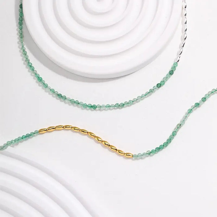 Verdant Green Quartz Necklace by Anaïs & Aimee displayed on a minimalist white background, highlighting its vibrant green quartz beads and elegant gold detailing.