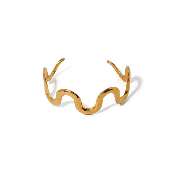 Gold wave-shaped cuff bracelet on a white background, highlighting its unique undulating design.