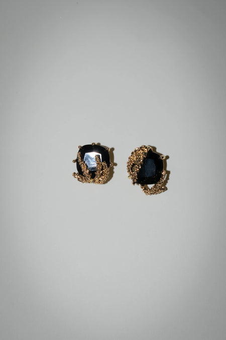 Patchouli Flower Black Gem Stud Earrings by Anaïs & Aimée, front view showcasing intricate gold detailing around a black gemstone."

Second Image: "Patchouli Flower Black Gem Stud Earrings by Anaïs &